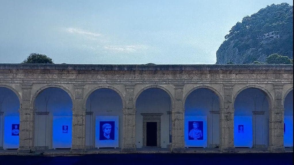 The Chiostro Grande at night, the portraits lit in blue