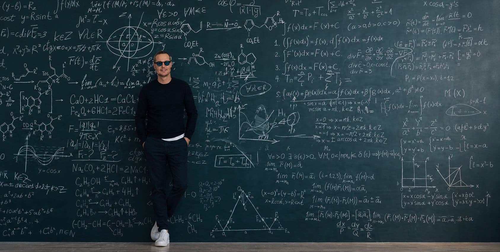 Conor Mccreedy in front of a chalkboard of equations